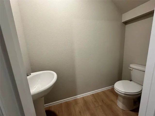 a white toilet sitting next to a white sink