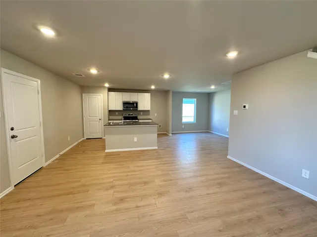 a view of kitchen with kitchen island microwave and stove