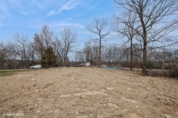 a view of yard covered with snow in front of house