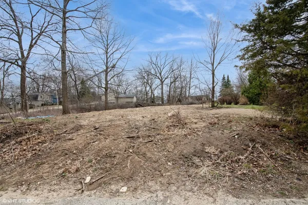a view of a yard with wooden fence