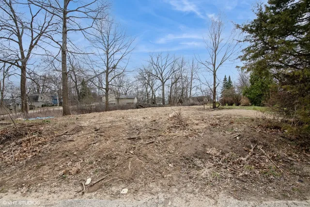 a view of a yard with wooden fence