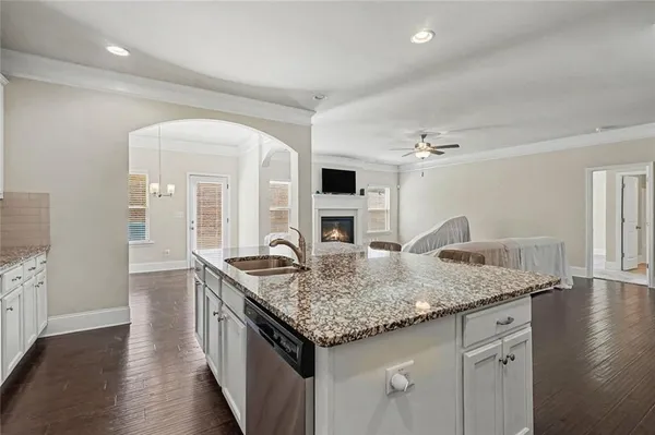 a kitchen with granite countertop stainless steel appliances a sink and a stove