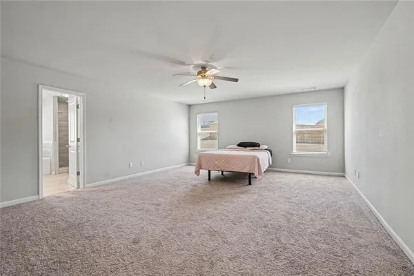 a view of a bedroom with a bed and a chandelier