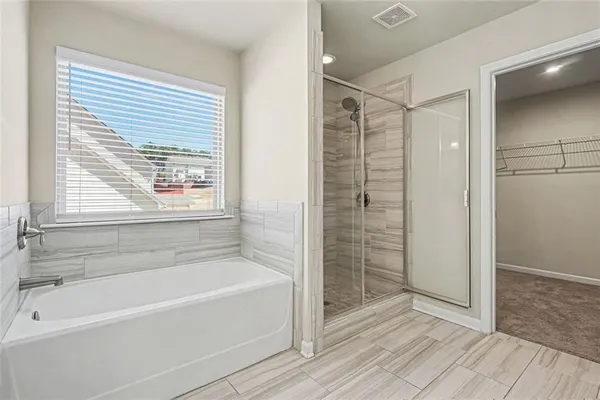a bathroom with a bathtub and a shower