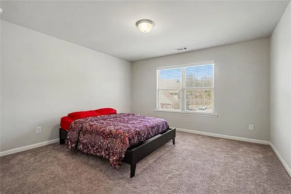 a living room with a bed and a window