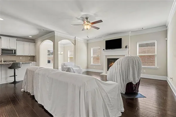 a living room with furniture fireplace and flat screen tv
