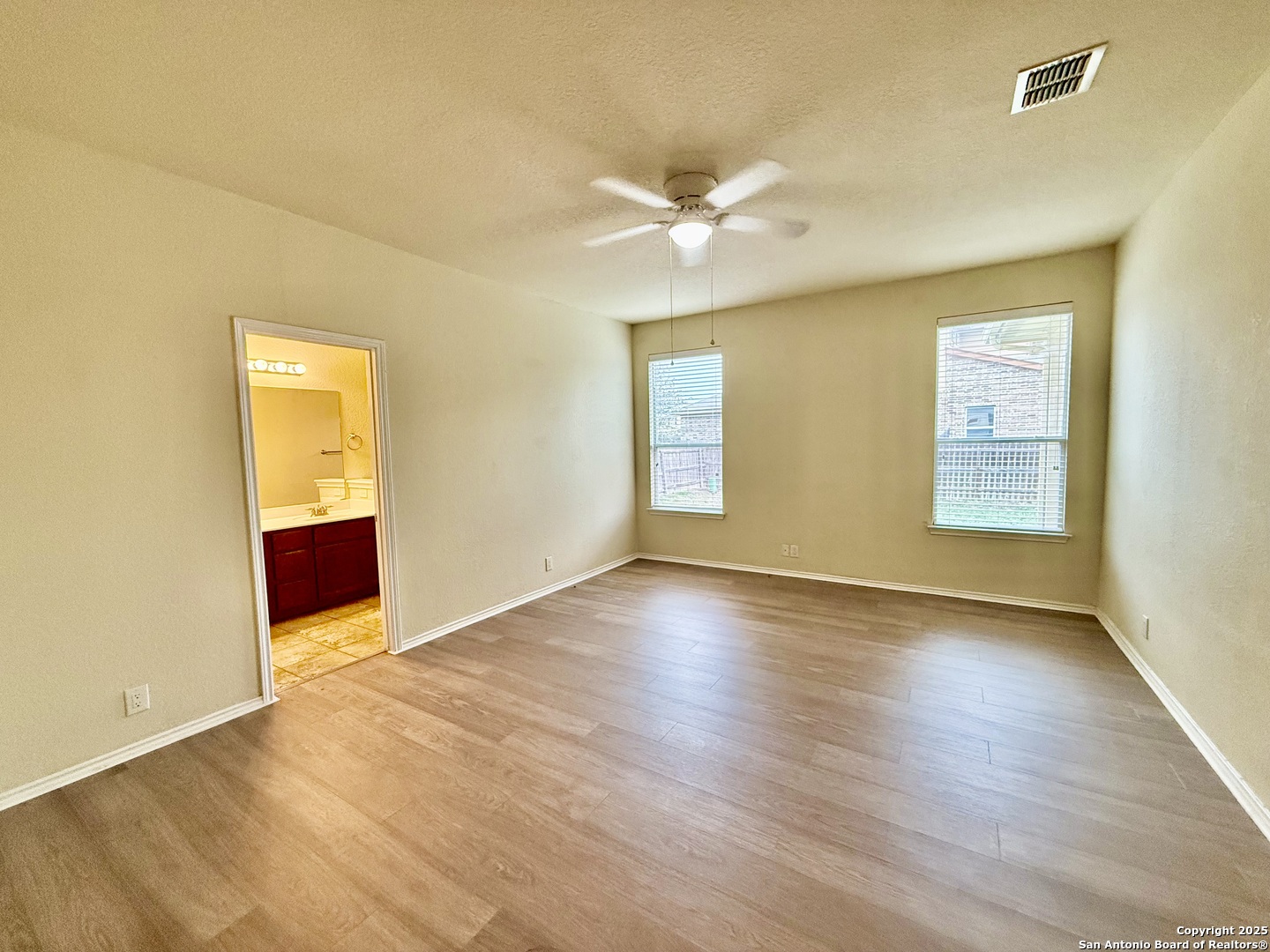 7015 Laguna Beach Converse, TX 78109 - Photo 11 of 39 a view of an empty room with wooden floor and a window