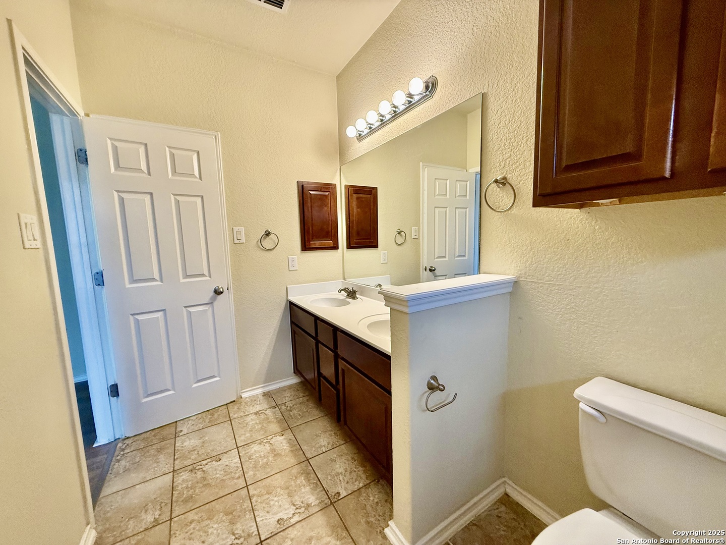 7015 Laguna Beach Converse, TX 78109 - Photo 15 of 39 a bathroom with a sink a toilet and mirror