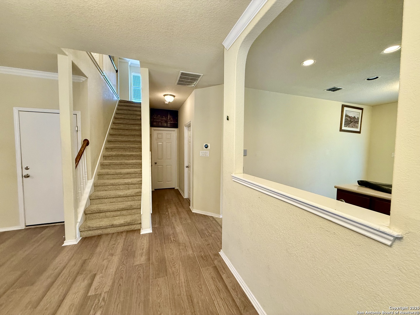 7015 Laguna Beach Converse, TX 78109 - Photo 21 of 39 a view of a hallway with wooden floor and staircase