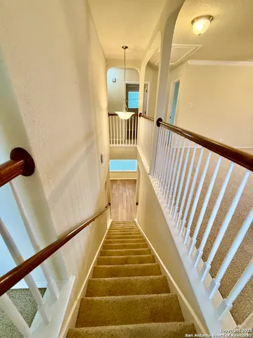 an empty room with windows and ceiling fan