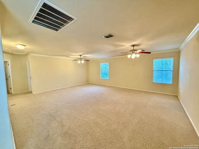 a view of a livingroom with a ceiling fan and a chandelier fan