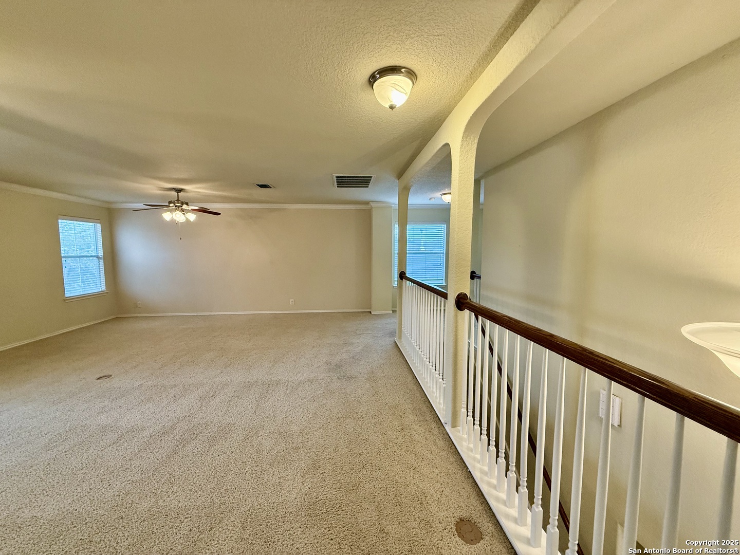 7015 Laguna Beach Converse, TX 78109 - Photo 25 of 39 a view of a hallway with wooden floor and staircase