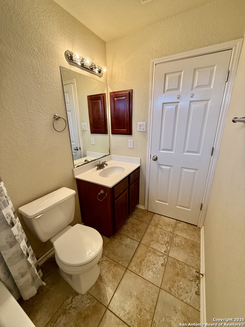 7015 Laguna Beach Converse, TX 78109 - Photo 30 of 39 a bathroom with a sink a toilet and mirror