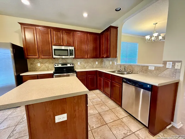 a kitchen with a sink a stove a microwave and refrigerator