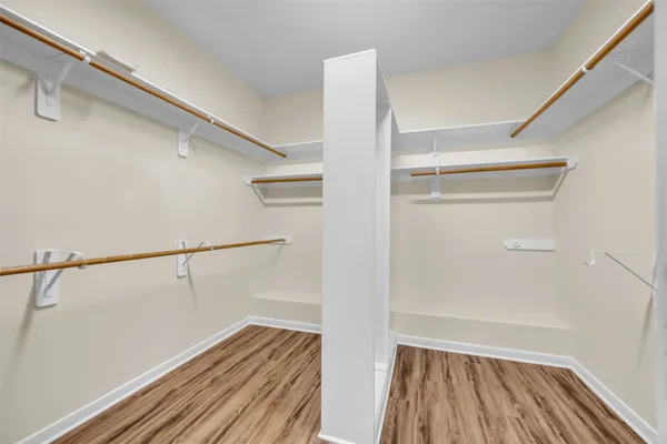 a view of walk in closet with empty racks