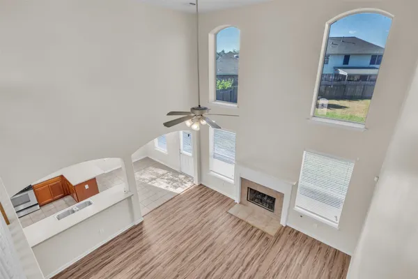 wooden floor in an empty room with a fireplace