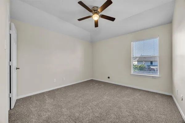 an empty room with closet and windows