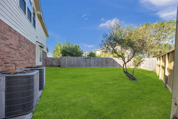 a view of house with backyard and garden