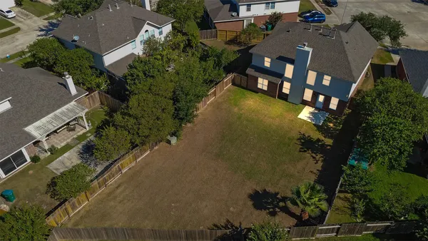an aerial view of a house with a yard