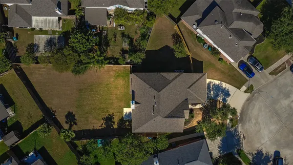 an aerial view of a house with a swimming pool