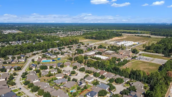 an aerial view of residential houses with outdoor space