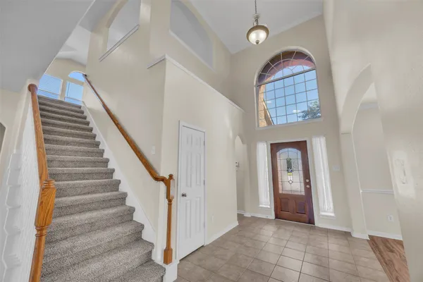 a view of entryway with hallway and stairs