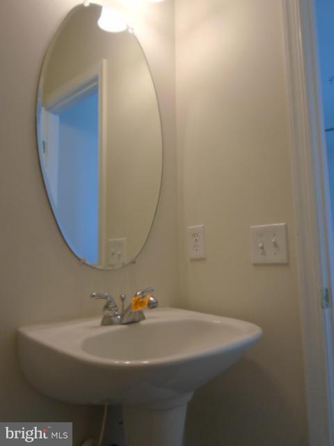 9718 Luguna Road Middle River, MD 21220 - Photo 11 of 29 a bathroom with a sink and mirror