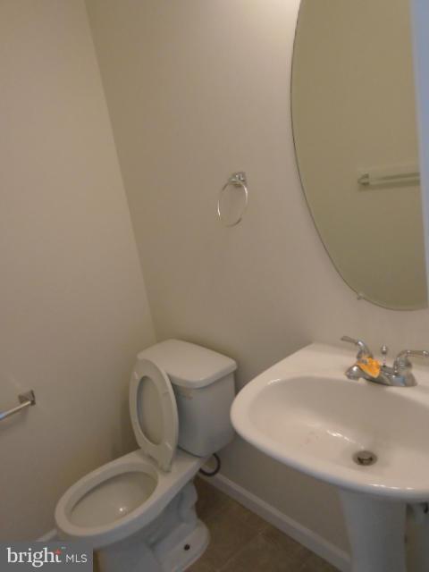 9718 Luguna Road Middle River, MD 21220 - Photo 12 of 29 a white toilet sitting next to a bathroom sink