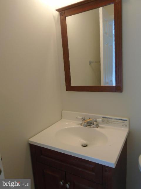 9718 Luguna Road Middle River, MD 21220 - Photo 25 of 29 a bathroom with a sink and a mirror