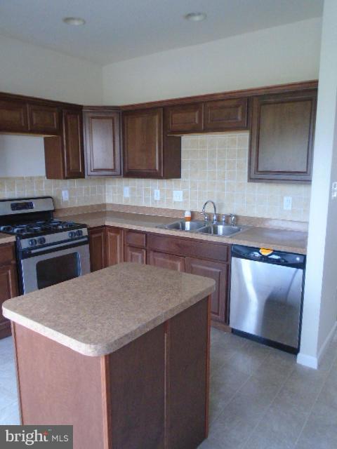 9718 Luguna Road Middle River, MD 21220 - Photo 5 of 29 a kitchen with stainless steel appliances granite countertop a sink stove and refrigerator