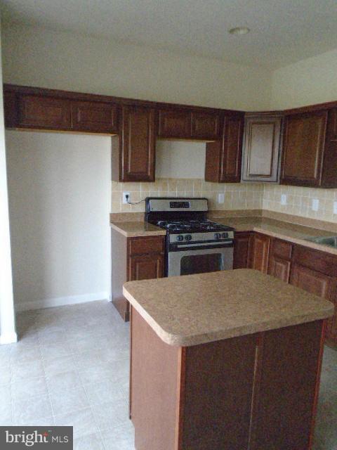 9718 Luguna Road Middle River, MD 21220 - Photo 6 of 29 a kitchen with stainless steel appliances a sink a stove a microwave a sink and cabinets