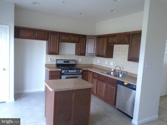9718 Luguna Road Middle River, MD 21220 - Photo 7 of 29 a kitchen with stainless steel appliances a sink stove refrigerator and cabinets