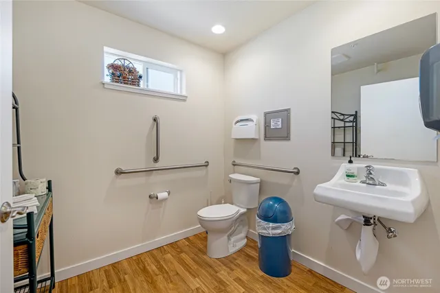 a bathroom with a sink a toilet and a mirror