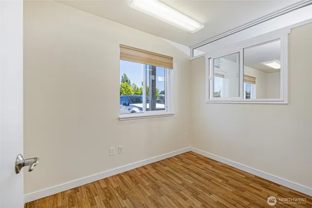 wooden floor in an empty room with a window