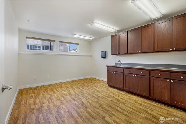 a kitchen with wooden cabinets and a sink