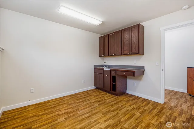 a kitchen with a sink and a stove top oven
