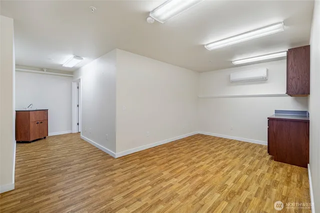 a view of an empty room and wooden floor