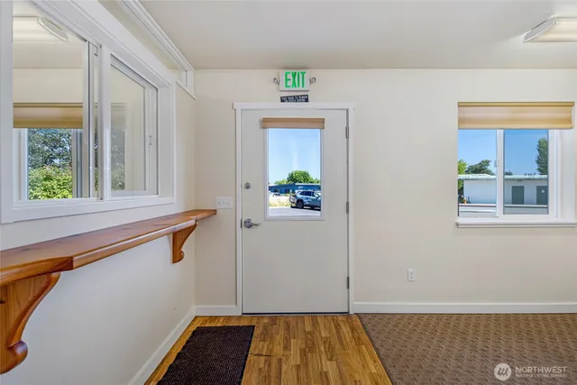 a view of an entryway with wooden floor and windows
