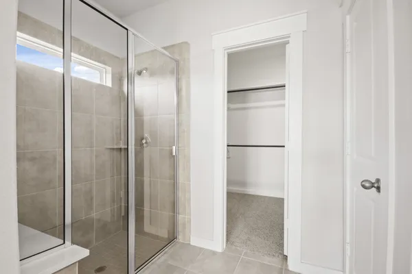 a bathroom with a glass shower door