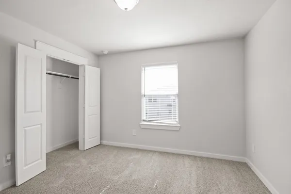 a view of a big room with windows and closet