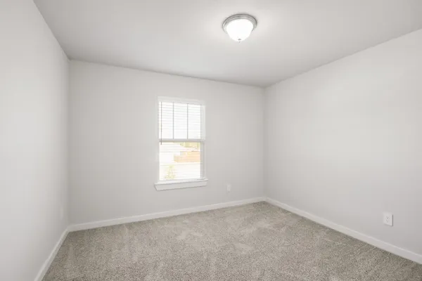 an empty room with closet area