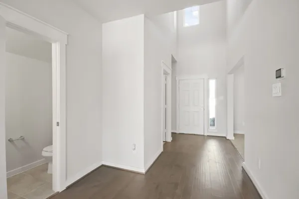 a view of a hallway with wooden floor