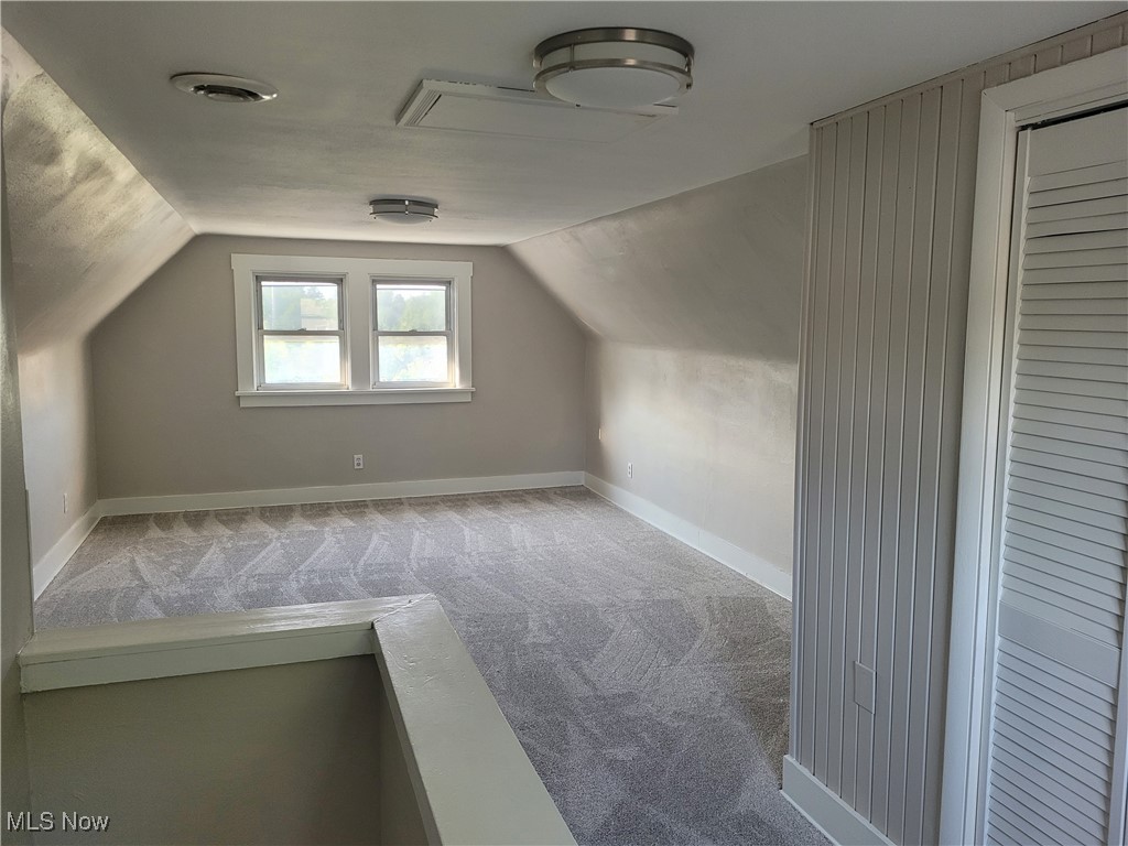 419 East Wilbeth Road Akron, OH 44301 - Photo 15 of 21 Additional living space with vaulted ceiling and carpet flooring