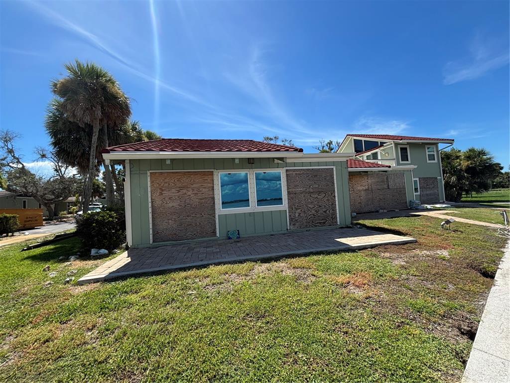 2985 North Beach Road, Unit C71 Englewood, FL 34223 - Photo 14 of 23 front view of a house with a yard