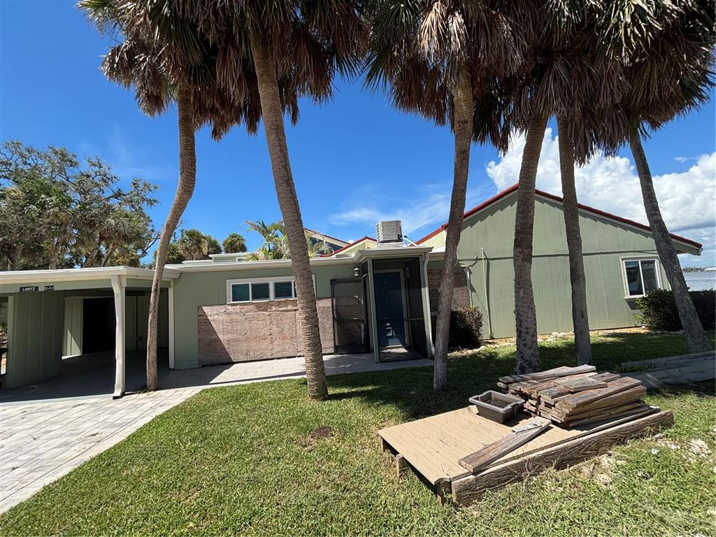 2985 North Beach Road, Unit C71 Englewood, FL 34223 - Photo 17 of 23 front view of house with a yard