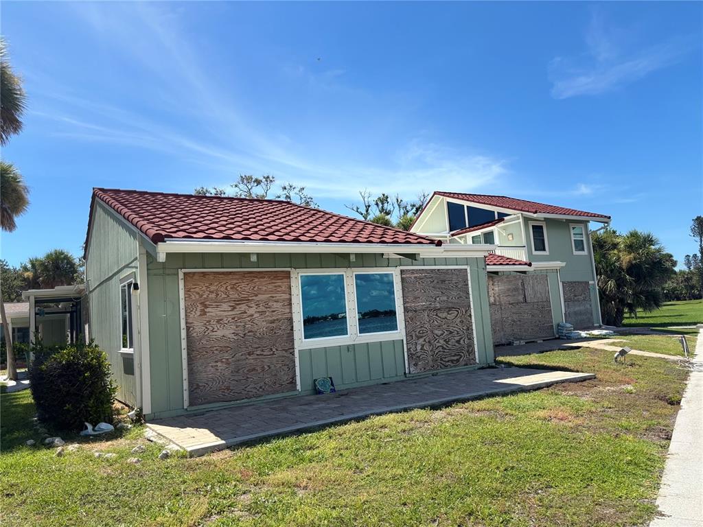 2985 North Beach Road, Unit C71 Englewood, FL 34223 - Photo 2 of 23 front view of a house with a yard