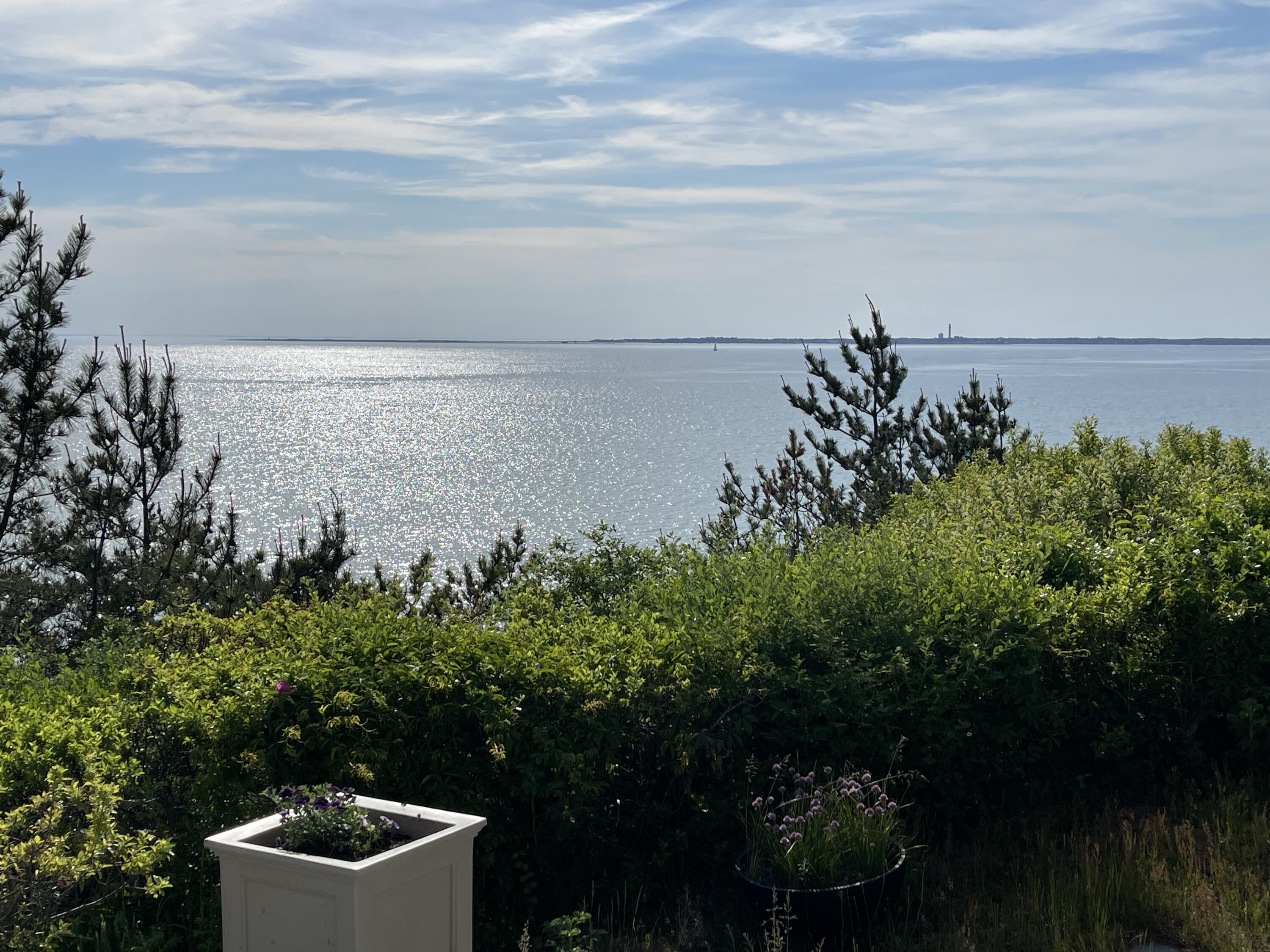 31 Bay View Road Truro, MA 02666 - Photo 25 of 54 a view of a lake with a big yard and potted plants