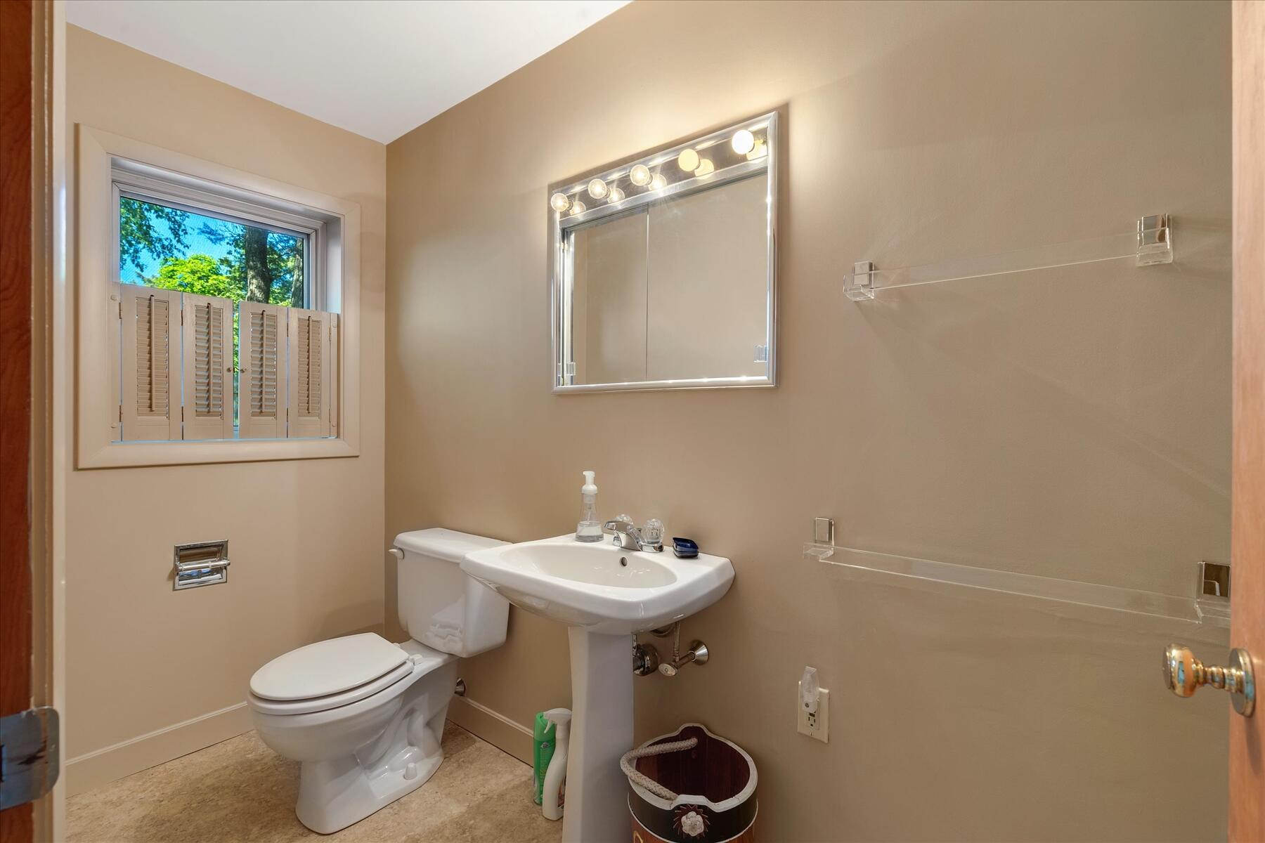 31 Bay View Road Truro, MA 02666 - Photo 48 of 54 a bathroom with a toilet sink and mirror