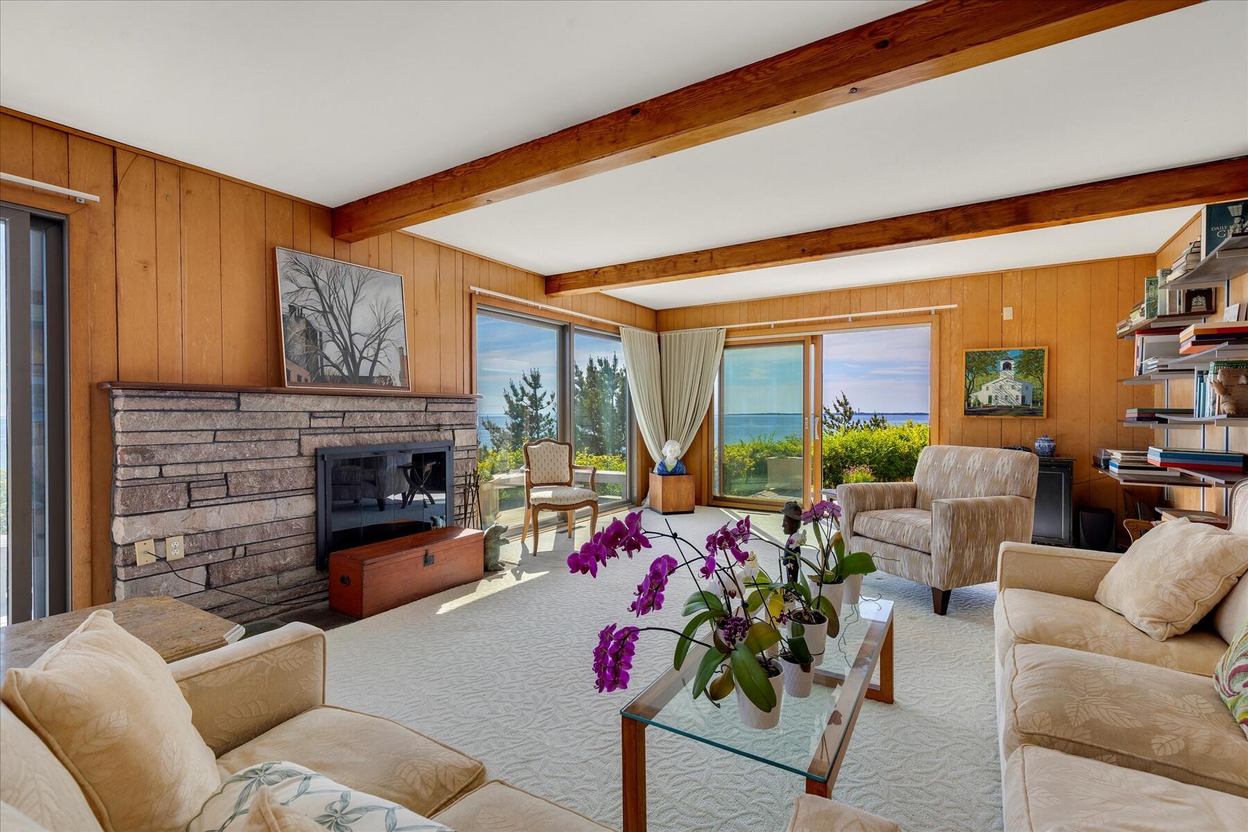 31 Bay View Road Truro, MA 02666 - Photo 7 of 54 a living room with furniture fireplace and a large window