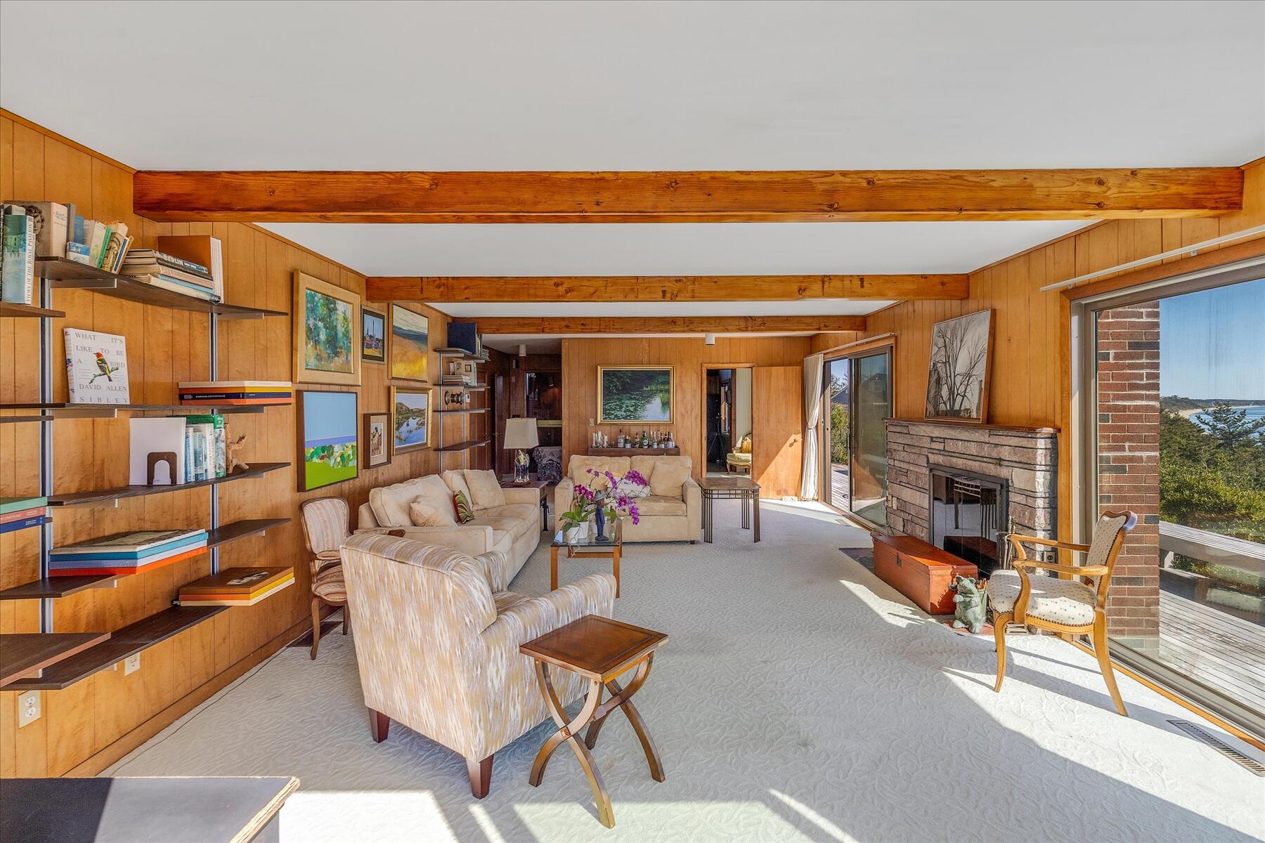 31 Bay View Road Truro, MA 02666 - Photo 8 of 54 a living room with patio furniture and a fireplace
